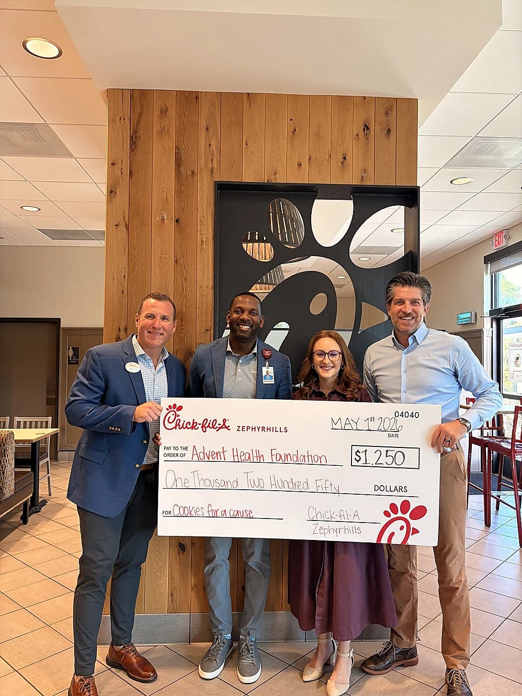 Chick-fil-A leaders presenting a Cookies for a Cause check to the AdventHealth Foundation