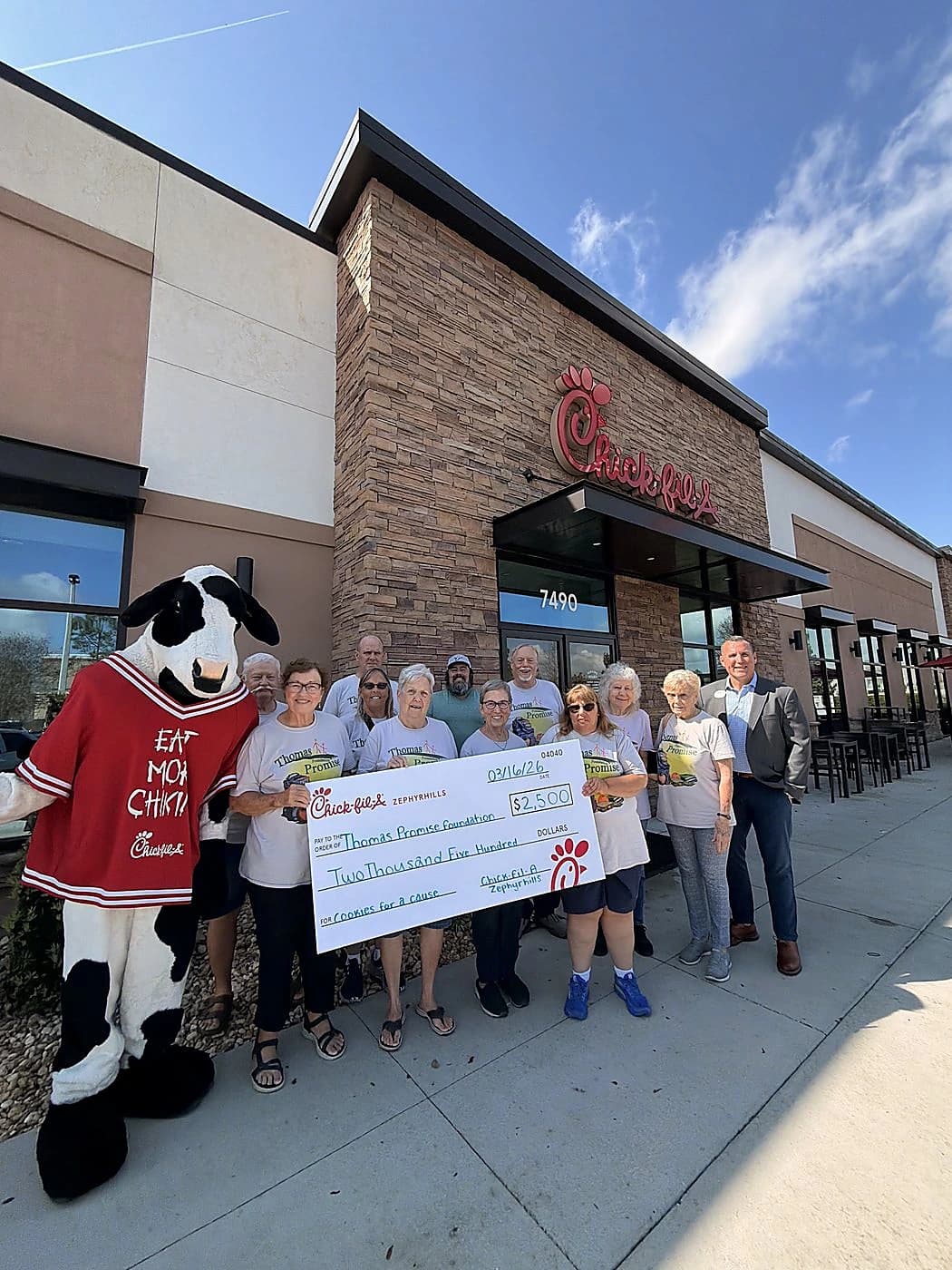 Thomas Promise Foundation team receiving a Cookies for a Cause check outside the restaurant